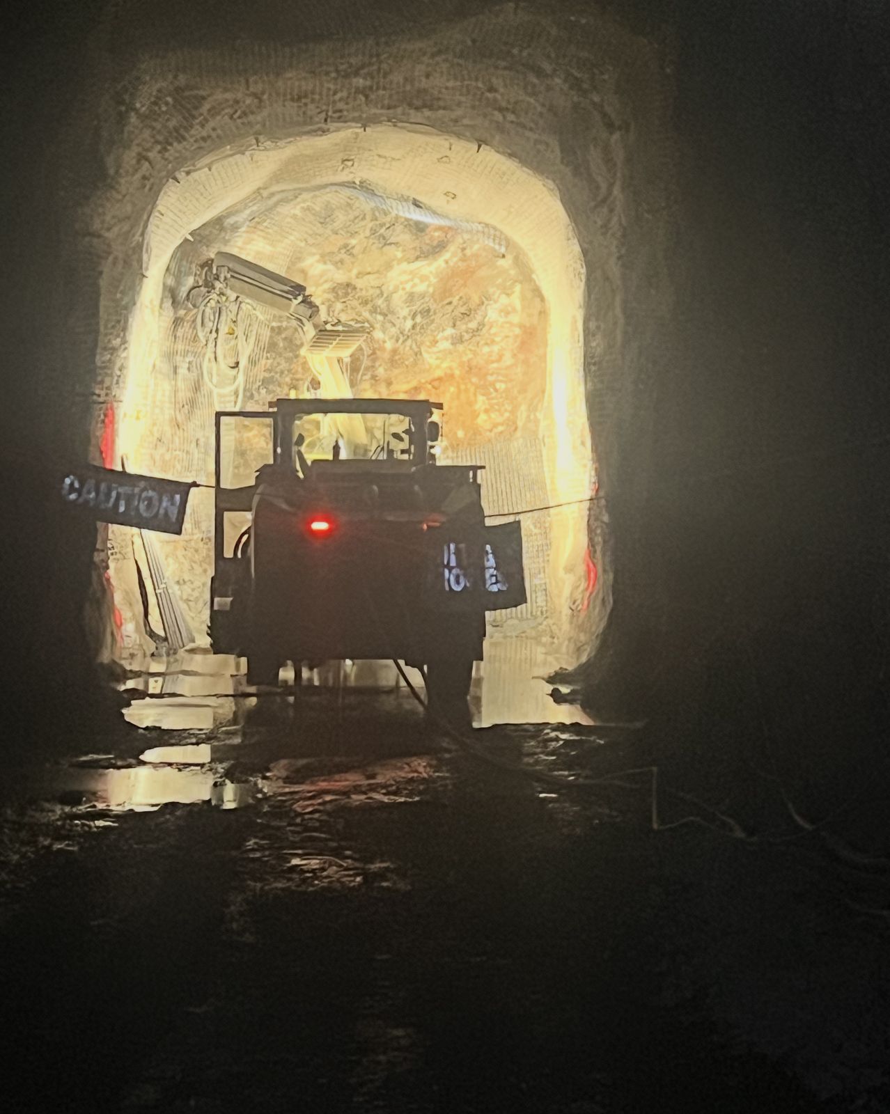 Underground bolter working behind a caution line