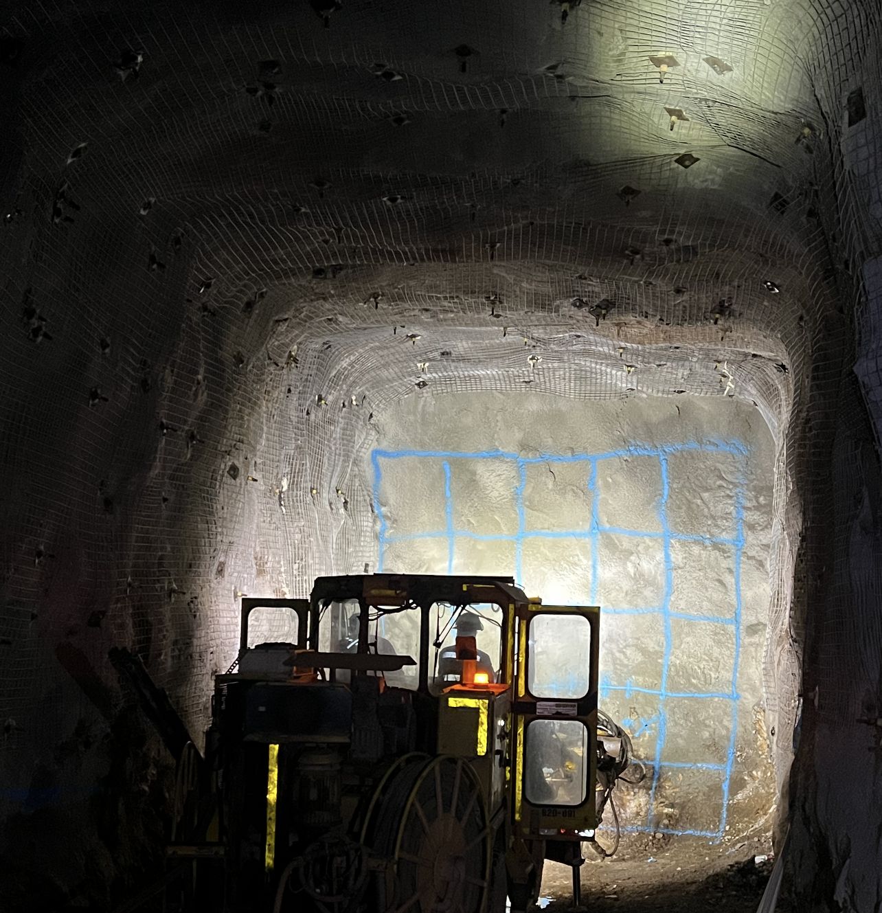 Underground jumbo at the face, marked with a blue paint grid