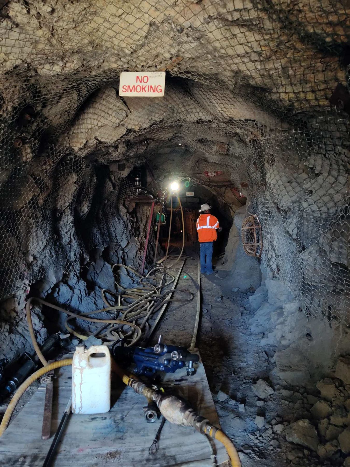 Underground drift with screened back and ribs, air lines and a jackleg drill
