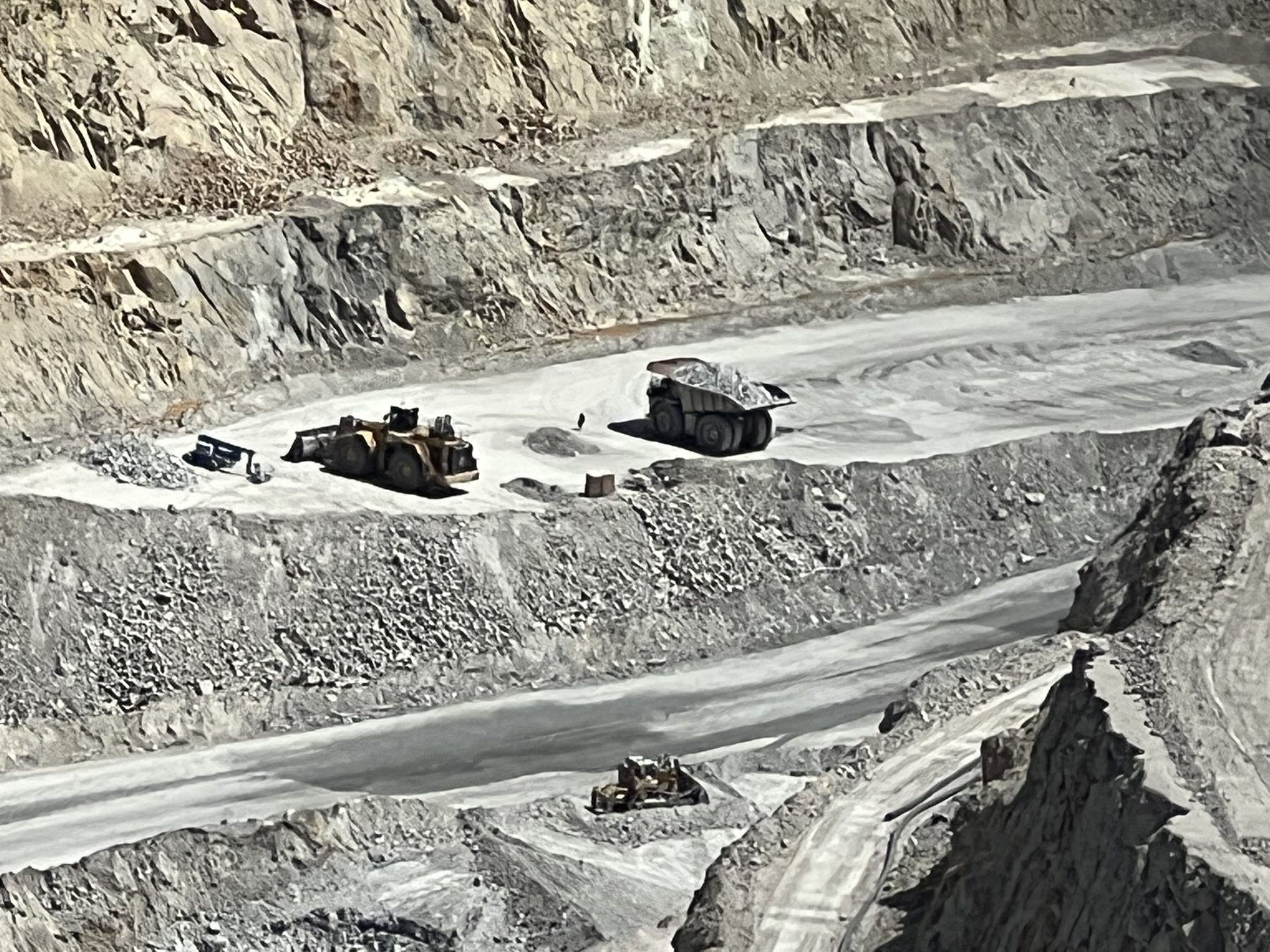 Loader filling a haul truck on an open-pit bench