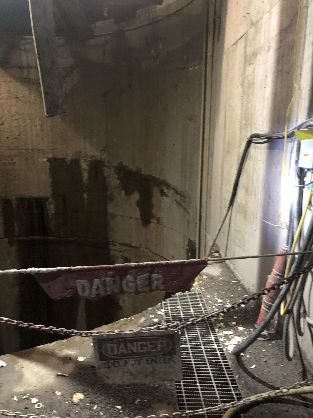 Shaft opening barricaded with DANGER flagging and a Do Not Enter sign