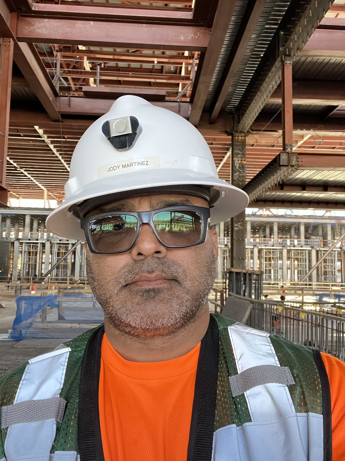 Jody Martinez on a capital project site in a hard hat with his name on it