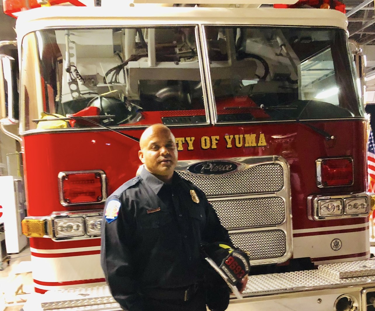 Jody Martinez in uniform in front of a City of Yuma fire engine